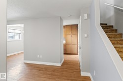 Corridor with light wood finished floors and a textured ceiling - 