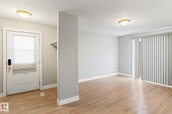 Unfurnished room with a textured ceiling and light wood-type flooring - 