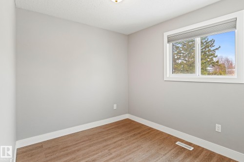 Unfurnished room featuring wood finished floors and a textured ceiling - 914 9 Street, Cold Lake, AB - Indoor Photo Showing Other Room