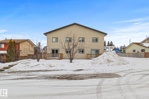 Snow covered back of property with a wooden deck - 914 9 Street, Cold Lake, AB - Outdoor