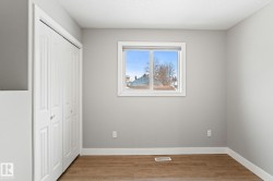Unfurnished bedroom with light wood-type flooring and a closet - 