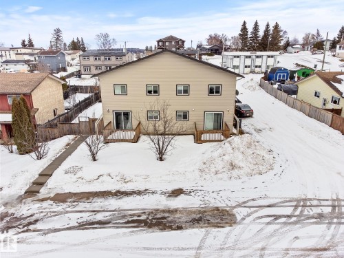 Snow covered rear of property featuring a wooden deck and a residential view - 914 9 Street, Cold Lake, AB - Outdoor