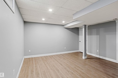 Finished basement featuring a paneled ceiling, light wood-type flooring, and recessed lighting - 914 9 Street, Cold Lake, AB - Indoor
