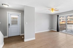 Spare room with light wood-style flooring, a ceiling fan, and a textured ceiling - 