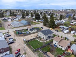 Residential neighborhood with scattered mature trees and varied architectural styles - 