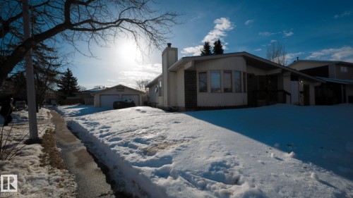 View of front facade featuring an outbuilding, a chimney, and a garage - 11 Austin Crescent, St. Albert, AB - Outdoor