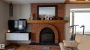 Detailed view of wood finished floors and a fireplace - 11 Austin Crescent, St. Albert, AB  - Indoor Photo Showing Living Room With Fireplace 