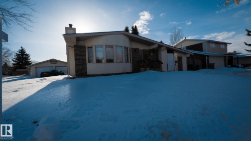 View of front of home with a chimney, a detached garage, and an outdoor structure - 11 Austin Crescent, St. Albert, AB - Outdoor