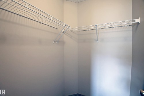 View of walk in closet - 8129 7 Avenue, Edmonton, AB - Indoor With Storage