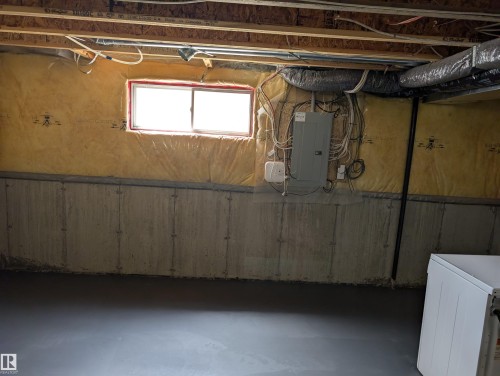 Below grade area featuring electric panel and washer / dryer - 8129 7 Avenue, Edmonton, AB - Indoor Photo Showing Basement