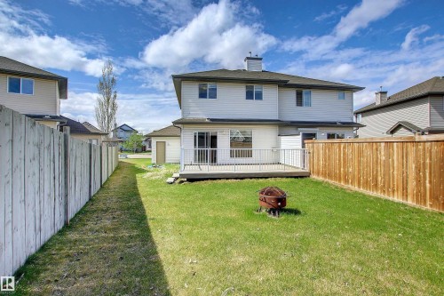 Back of property with an outdoor fire pit, a deck, a chimney, and a fenced backyard - 8129 7 Avenue, Edmonton, AB - Outdoor With Deck Patio Veranda With Exterior