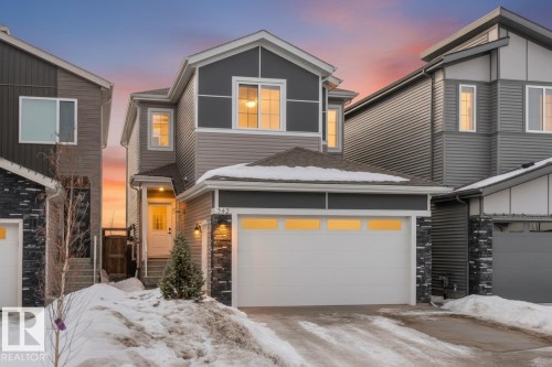 View of front of house featuring stone siding and driveway - 342 Meadowview Drive, Fort Saskatchewan, AB - Outdoor With Facade