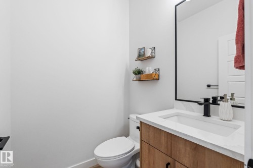Half bathroom featuring vanity and toilet - 342 Meadowview Drive, Fort Saskatchewan, AB - Indoor Photo Showing Bathroom