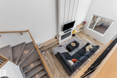 Living area featuring light wood-type flooring and a high ceiling - 342 Meadowview Drive, Fort Saskatchewan, AB - Indoor Photo Showing Other Room