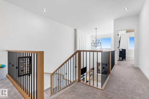 Hall featuring carpet floors and suspended lighting - 342 Meadowview Drive, Fort Saskatchewan, AB - Indoor Photo Showing Other Room