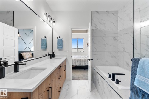 Bathroom with connected bathroom, light marble finish flooring, a bath, and double vanity - 342 Meadowview Drive, Fort Saskatchewan, AB - Indoor Photo Showing Bathroom