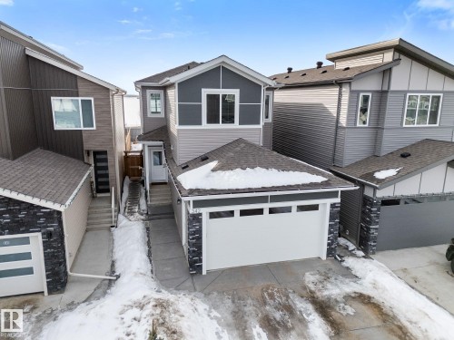 View of front of property with a garage and roof with shingles - 342 Meadowview Drive, Fort Saskatchewan, AB - Outdoor
