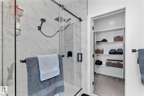 Bathroom featuring carpet, a spacious closet, and a marble finish shower - 342 Meadowview Drive, Fort Saskatchewan, AB - Indoor Photo Showing Bathroom