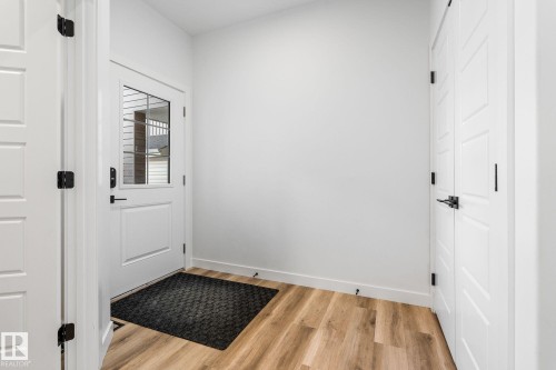 Doorway to outside featuring baseboards and wood finished floors - 342 Meadowview Drive, Fort Saskatchewan, AB - Indoor Photo Showing Other Room