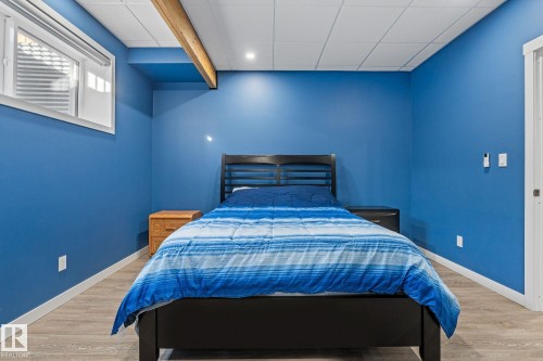 Bedroom with light wood-type flooring and a paneled ceiling - 342 Meadowview Drive, Fort Saskatchewan, AB - Indoor Photo Showing Bedroom