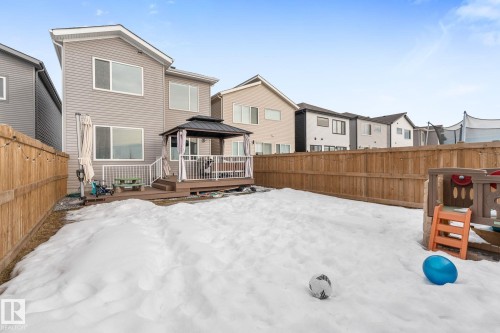 Snow covered back of property featuring a gazebo, a fenced backyard, a residential view, and a deck - 342 Meadowview Drive, Fort Saskatchewan, AB - Outdoor With Deck Patio Veranda