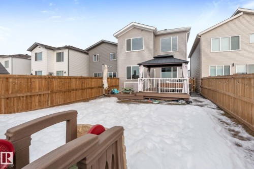 Snow covered rear of property with a gazebo, a fenced backyard, a wooden deck, and a residential view - 342 Meadowview Drive, Fort Saskatchewan, AB - Outdoor With Exterior
