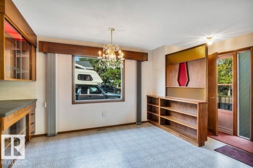 Unfurnished dining area with light floors and suspended lighting - 4314 52 Street, Wetaskiwin, AB - Indoor Photo Showing Other Room