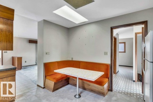 Dining space featuring a skylight and light carpet - 4314 52 Street, Wetaskiwin, AB - Indoor Photo Showing Other Room