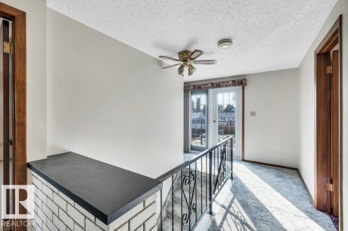 Corridor featuring a textured ceiling and carpet - 4314 52 Street, Wetaskiwin, AB - Indoor Photo Showing Other Room