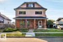 View of front of house with a porch, a front lawn, brick siding, and stucco siding - 4314 52 Street, Wetaskiwin, AB  - Outdoor 