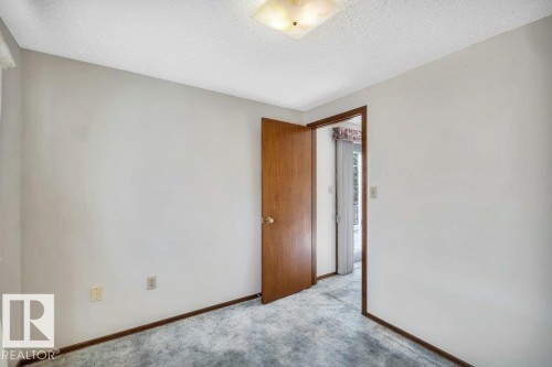 Unfurnished room with a textured ceiling and carpet floors - 4314 52 Street, Wetaskiwin, AB - Indoor Photo Showing Other Room