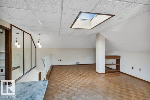 Bonus room with parquet flooring and a skylight - 4314 52 Street, Wetaskiwin, AB - Indoor Photo Showing Other Room
