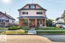 View of front of house featuring a porch, a front lawn, brick siding, and stucco siding - 4314 52 Street, Wetaskiwin, AB  - Outdoor With Deck Patio Veranda 