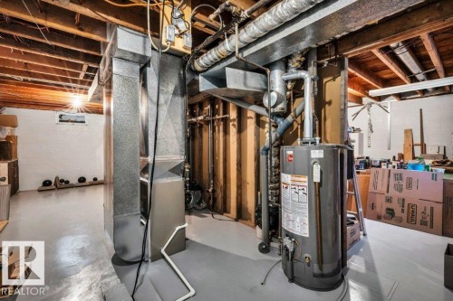 Utility room featuring gas water heater and heating unit - 4314 52 Street, Wetaskiwin, AB - Indoor Photo Showing Basement