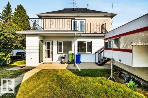 Back of house featuring a lawn, a patio area, and a balcony - 4314 52 Street, Wetaskiwin, AB - Outdoor