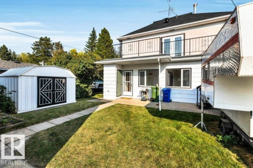Rear view of house with a lawn, a balcony, a shed, and a patio - 4314 52 Street, Wetaskiwin, AB - Outdoor