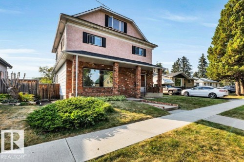 Traditional style home with brick siding, a porch, and stucco siding - 4314 52 Street, Wetaskiwin, AB - Outdoor With Deck Patio Veranda