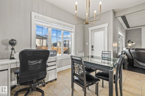 Dining space featuring a chandelier, light tile patterned floors, and a desk - 167 Bremner Crescent, Fort Saskatchewan, AB - Indoor