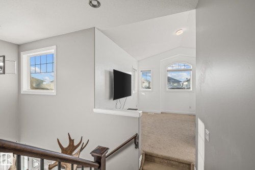 Staircase with carpet and plenty of natural light - 167 Bremner Crescent, Fort Saskatchewan, AB - Indoor Photo Showing Other Room