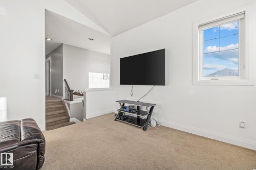 Living area with carpet floors, lofted ceiling, and recessed lighting - 167 Bremner Crescent, Fort Saskatchewan, AB - Indoor