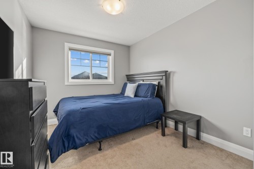 Bedroom with light colored carpet and baseboards - 167 Bremner Crescent, Fort Saskatchewan, AB - Indoor Photo Showing Bedroom