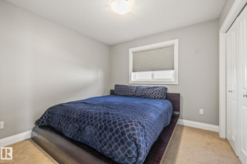 Bedroom featuring a closet, a textured ceiling, and light carpet - 167 Bremner Crescent, Fort Saskatchewan, AB - Indoor Photo Showing Bedroom