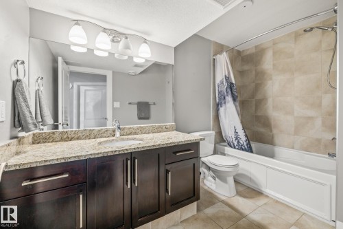 Full bath with shower / tub combo, vanity, light tile patterned floors, and a textured ceiling - 167 Bremner Crescent, Fort Saskatchewan, AB - Indoor Photo Showing Bathroom