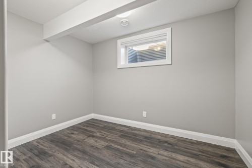 Unfurnished room with dark wood finished floors and baseboards - 167 Bremner Crescent, Fort Saskatchewan, AB - Indoor Photo Showing Other Room