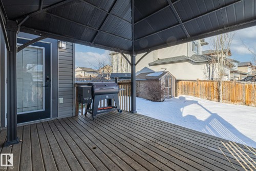 Wooden deck featuring a grill, a residential view, a fenced backyard, and a storage unit - 167 Bremner Crescent, Fort Saskatchewan, AB - Outdoor With Deck Patio Veranda With Exterior