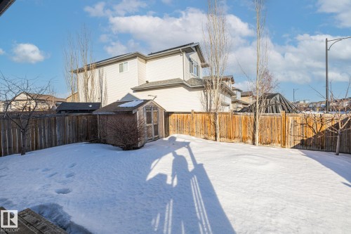 Fenced backyard with a storage shed and a residential view - 167 Bremner Crescent, Fort Saskatchewan, AB - Outdoor