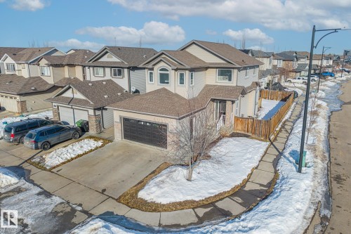 View of front of house with a residential view, driveway, and roof with shingles - 167 Bremner Crescent, Fort Saskatchewan, AB - Outdoor