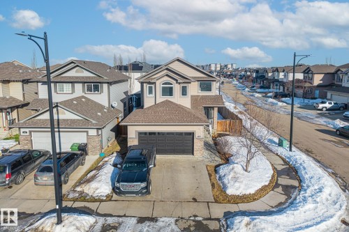 View of front facade with a residential view, a garage, concrete driveway, and a shingled roof - 167 Bremner Crescent, Fort Saskatchewan, AB - Outdoor With Facade