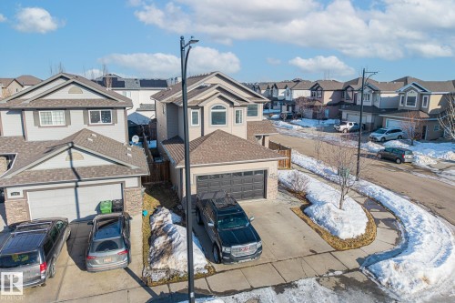 View of front facade featuring a residential view, a garage, driveway, and roof with shingles - 167 Bremner Crescent, Fort Saskatchewan, AB - Outdoor With Facade