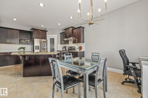 Dining room with a chandelier and light tile patterned floors - 167 Bremner Crescent, Fort Saskatchewan, AB - Indoor